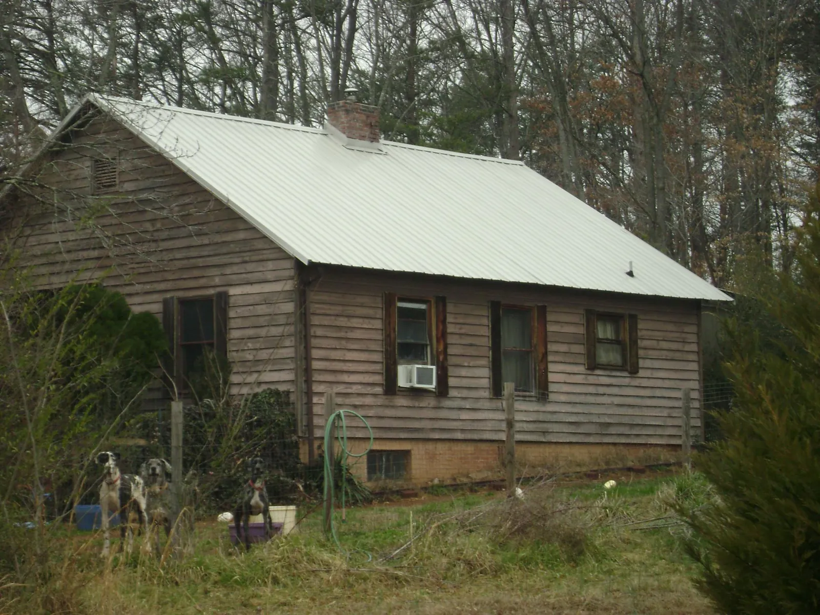 White metal roof on an old wood sided farmhouse, from a Metal Roof Installation job in Glen Alpine